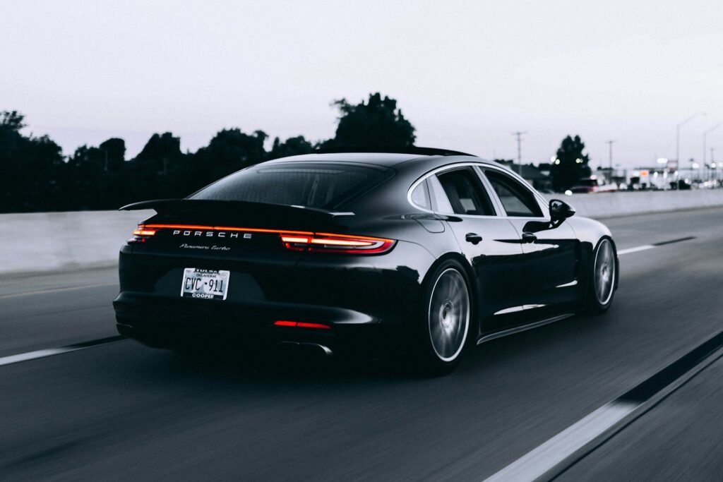 running black Porsche sedan. Best Aftermarket Wheels for Porsche 911
