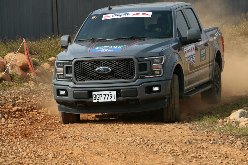 Gray Ford F150 driving fast on a rocky dirt road during an offroad adventure race. Best Dash Cam for Ford F150