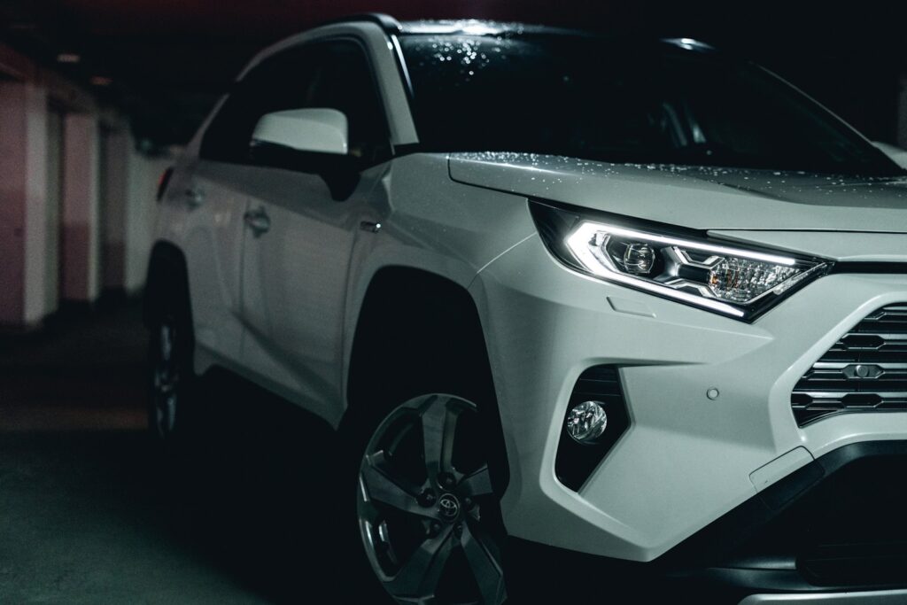 white and black car on black asphalt road. Best Cell Phone Holder for Toyota Rav4
