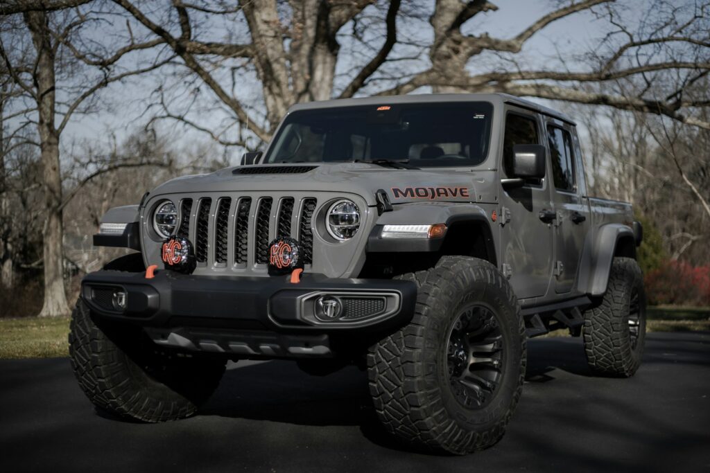 black and gray jeep wrangler on snow covered ground. Best Camper Shell for Jeep Gladiator